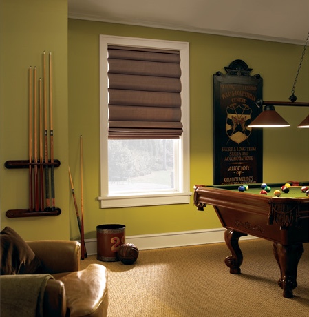 Roman shades in Miami game room with green walls.